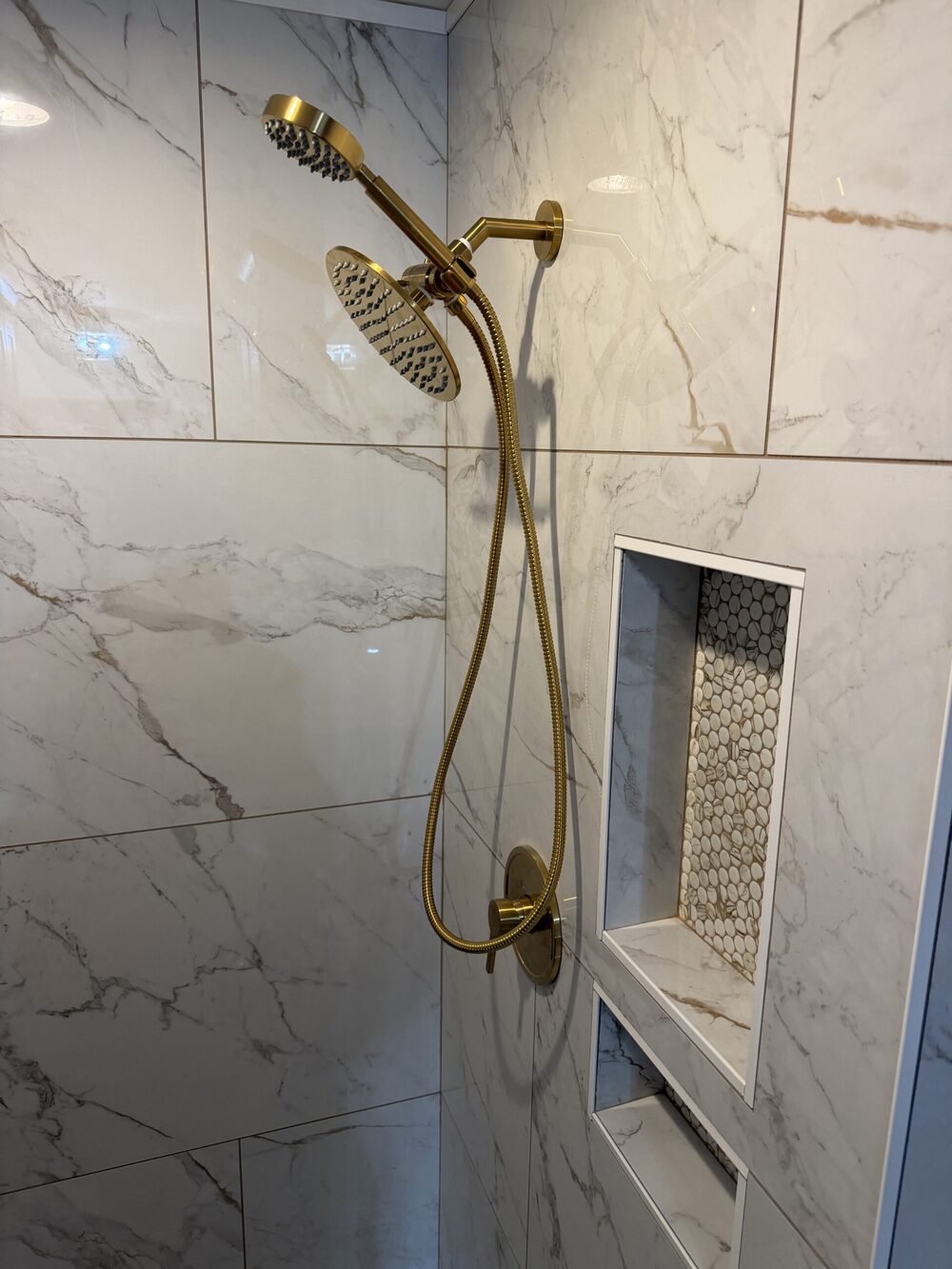 Gold shower system and marble tile installation
